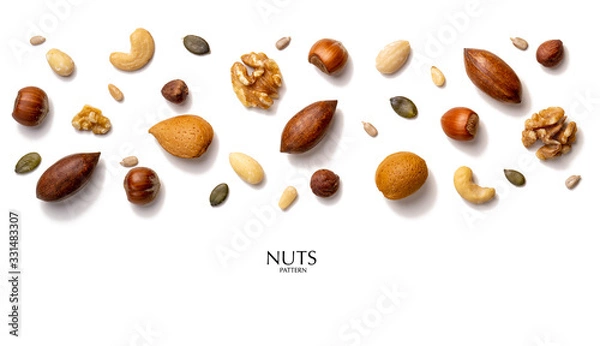 Obraz Creative layout made of hazelnut nuts, almonds, walnut, peanut, pecan, sunflower seeds. Flat lay with copy space. Fresh food concept. Nuts isolated on white background.
