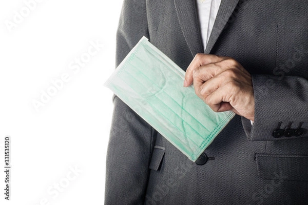Obraz Man in gray suit holding face mask