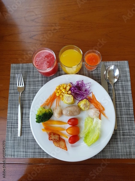 Obraz Top view of sausage, dumplings, salads and fresh juices wooden background copy space.  Nutritious food and drink concept.