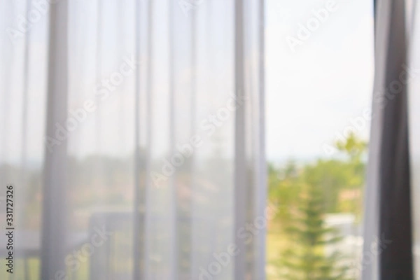 Fototapeta window curtain with green garden abstract blur background