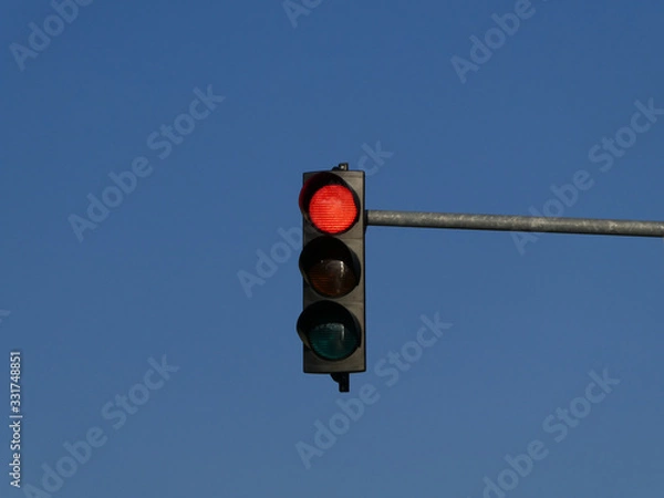 Fototapeta Red color on the traffic light with blue sky in background