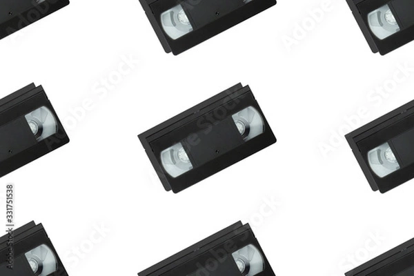 Fototapeta Seamless pattern with retro vhs tapes flat lay isolated on white background top view. Creative fashion design in minimal retro 80-s style. Film, tv concept. Web banner template. Stock photo.