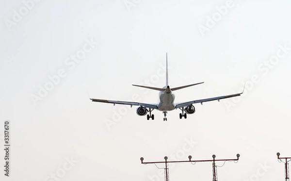 Fototapeta plane landing over guide towers