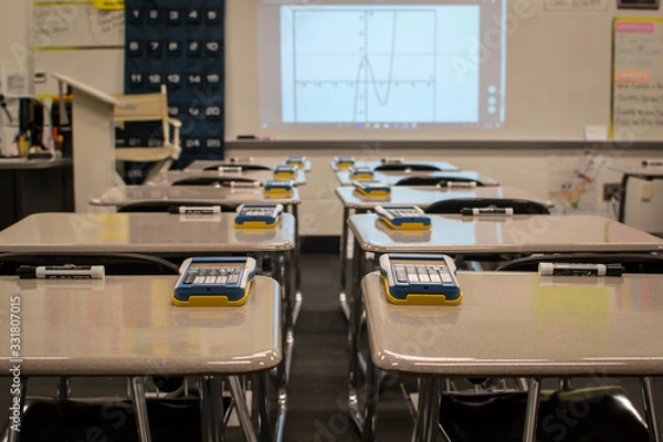Fototapeta Classroom desks with calculators