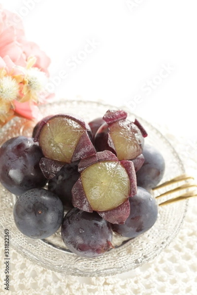 Obraz peeled Japanese grape on dish with copy space
