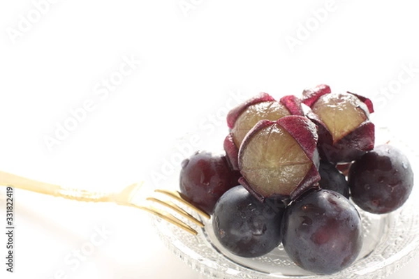 Obraz peeled Japanese grape on dish with copy space