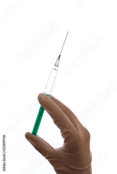 Obraz Hand with sterile glove holding syringe with vaccine against coronavirus covid-19 SARS-CoV-2