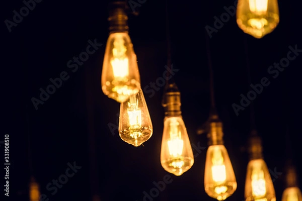 Fototapeta retro edison light bulb in the dark