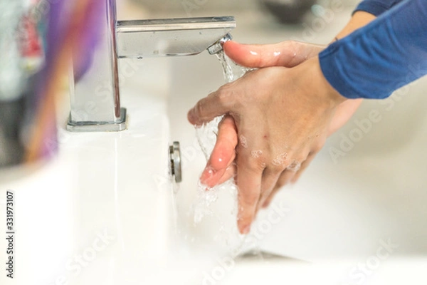 Fototapeta nurse shows how to properly wash your hands with soap to prevent coronavirus infections and prevent the spread of the world pandemic