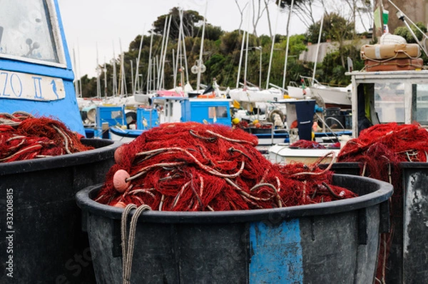 Fototapeta fishermans boats in little harbor with nets drying in the sun