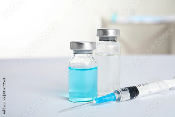 Fototapeta Vials and syringe on light background. Vaccination and immunization