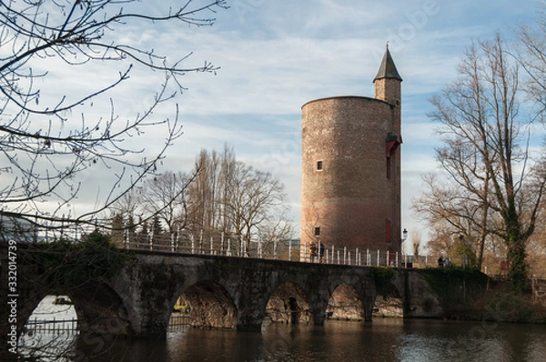 Obraz Tower over river bridge during sunset