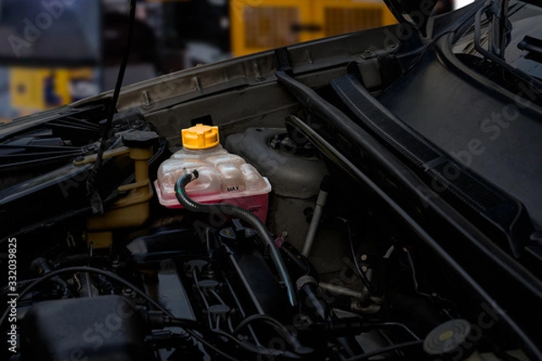 Fototapeta Topic of car repair shop: car coolant system. maintenance fluids or products for the radiator, cylinder head and overheating problems