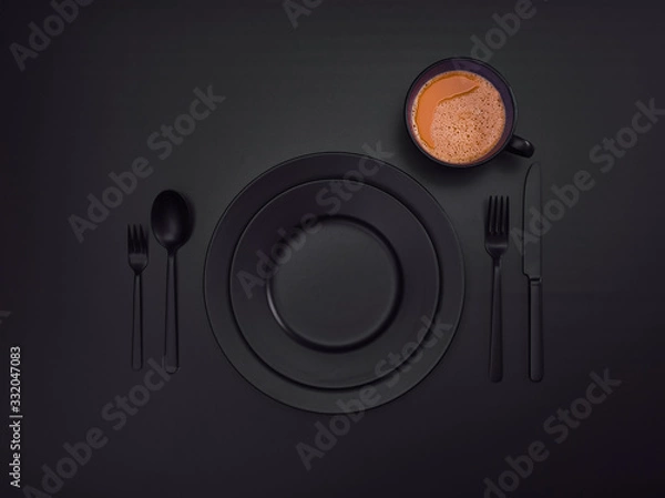Fototapeta Cup of coffee with blue plates, fork, knife and spoon, top view. Ceramic dishes with a set of cutlery. Empty blue dishes for breakfast or dinner in a restaurant. Copyspace for your individual text.