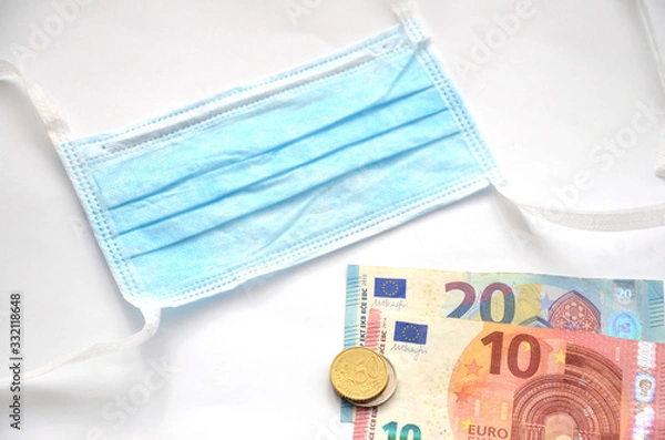 Fototapeta Surgical mask next to euro money on white background