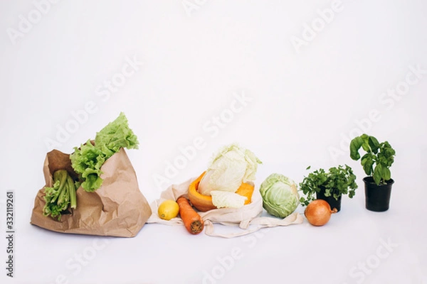 Obraz Zero waste concept. Package-free food shopping. Eco friendly natural bag with organic fruits and vegetables. Sustainable lifestyle concept. Plastic free items. Reuse, reduce, refuse. Isolated on white