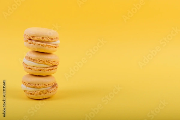 Fototapeta Colorful macaroons cake, sweet macaroon on yellow background, food background