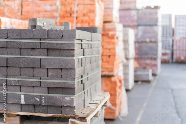 Fototapeta Construction Materials. Building materials for construction of residential complex. Pile of white bricks at construction site