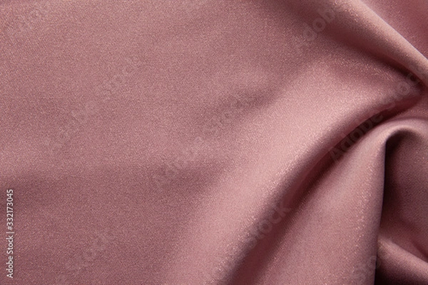 Fototapeta Beautiful fabric of one color is folded on a table in daylight