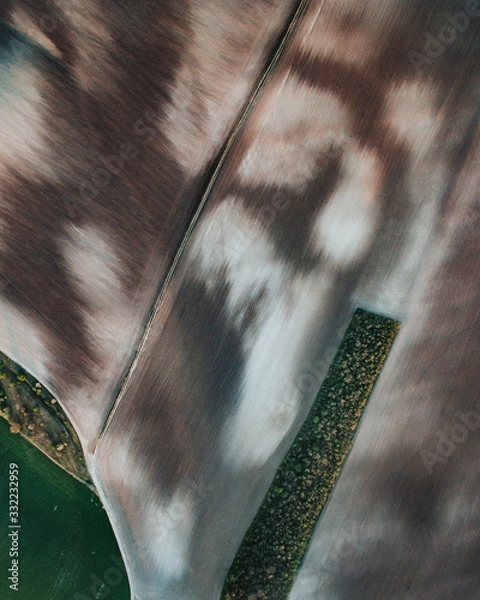 Fototapeta Aerial view ; Rows of soil before planting.Furrows row pattern in a plowed field prepared for planting crops in spring.Horizontal view in perspective.