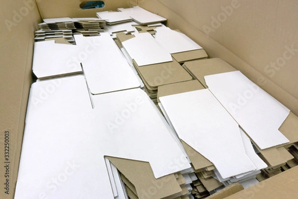 Obraz A lot of cardboard packaging for mugs. Disassembled condition, not folded. White color outside. Production. Wholesale and retail trade. Side view.