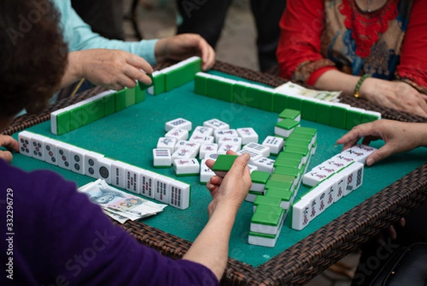 Obraz people playing mahjong in a tea garden in china