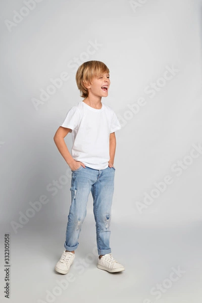 Obraz Happy little boy in casual outfit on light grey background