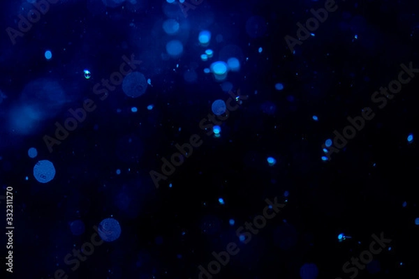 Fototapeta Blur blue bokeh of light on black