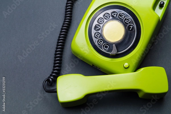 Fototapeta Classic phone with handset. vintage green telephone with phone receiver. office background. old communication technology