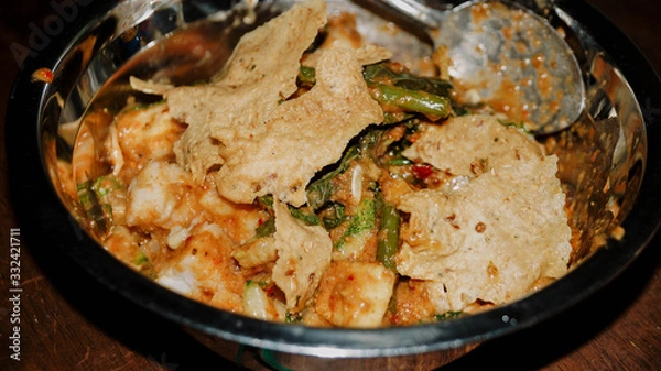 Obraz Close-up of Pecel - Traditional Javanese salad, consisting of mixed vegetables in a peanut sauce dressing, served with omelet.