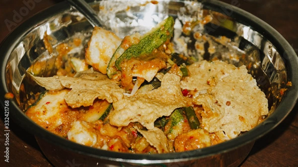 Obraz Close-up of Pecel - Traditional Javanese salad, consisting of mixed vegetables in a peanut sauce dressing, served with omelet.