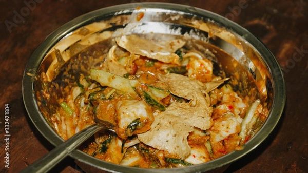 Obraz Close-up of Pecel - Traditional Javanese salad, consisting of mixed vegetables in a peanut sauce dressing, served with omelet.