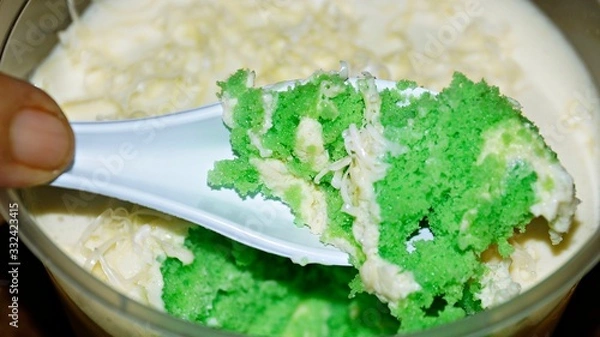 Obraz Close up Pandan leaf cheesecake on wooden background. Selective focus depth of field. (image contain certain grain or noise and soft focus when view at full resolution).