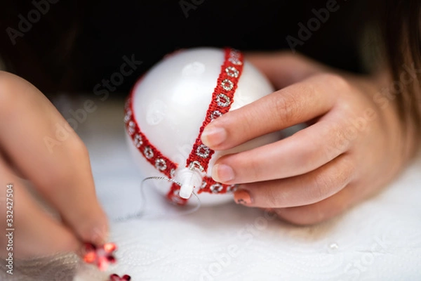 Fototapeta Creative diy hobby. Making handmade craft white stylish Christmas balls with lace.