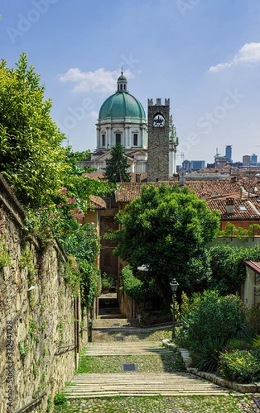 Obraz Steep street in Brescia, view of the dome Catedral of Santa Maria Assunta. Italy. Soft focus blurred background/