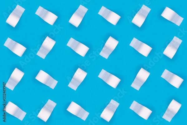 Fototapeta Pattern of toilet paper rolls on the bright blue background. Coronavirus COVID-19 pandemic panic shopping, social distancing concept. Bright monochrome drop