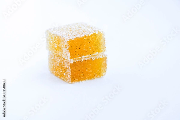 Fototapeta Pineapple, lemon, vanilla pate de fruit (jelly, marmalade, fruit candy) covered with sugar. White background, back view. There is a sliced jelly on a photo to show a texture inside of pate de fruit.