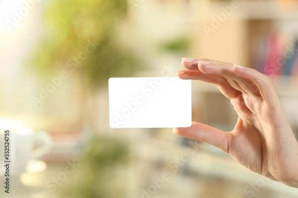 Fototapeta Woman hand showing mockup credit card at home