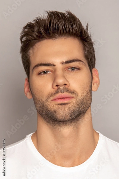 Obraz Muscle strong face beautiful stripped male model portrait in denim blue jeans white t-shirt on grey isolated font background with shadow