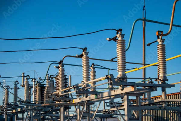 Fototapeta Power unit parts, high voltage insulation. Switchgears and switches in a power plant. High voltage to low voltage current converters.