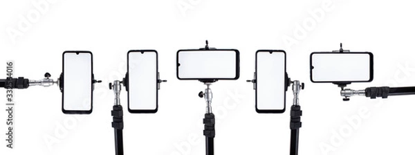 Obraz A lot of smartphones mounted on tripods and holders in different positions on a white isolated background.