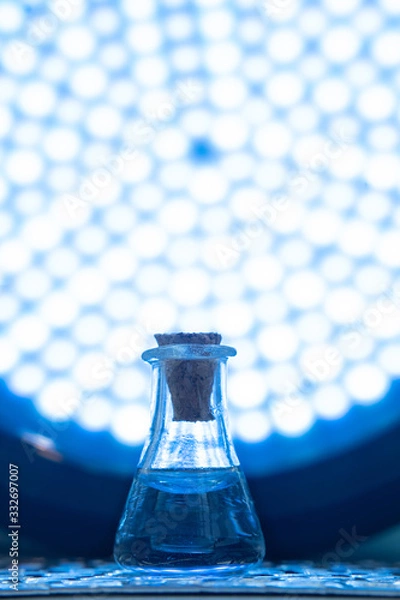Obraz Test tube with color solution on blue laboratory background