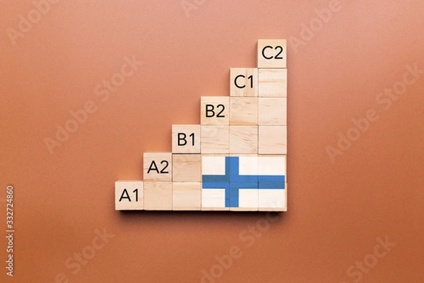 Fototapeta Wooden cubes with language levels, concept of learning and improvement. Finnish language