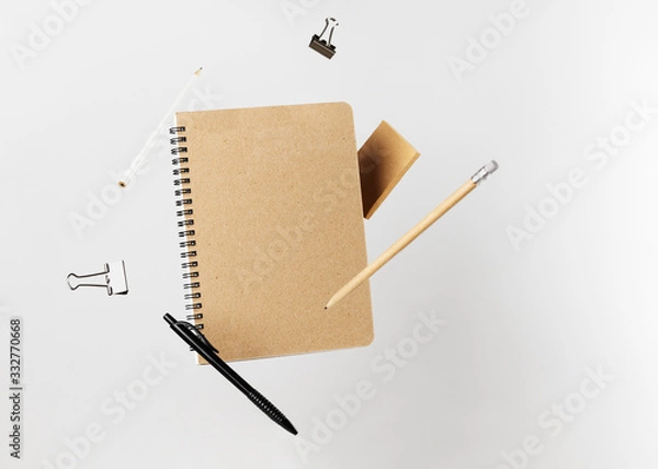 Obraz Stationery set. Levitation of notepad, pencils, pen, sticker and binder clips. Copy space on notebook and notes. Writing tools. Office supplies. Isolated on gray backdrop