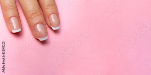 Obraz female fingers with beautiful manicure on a pink background. high resolution widescreen image. copy space