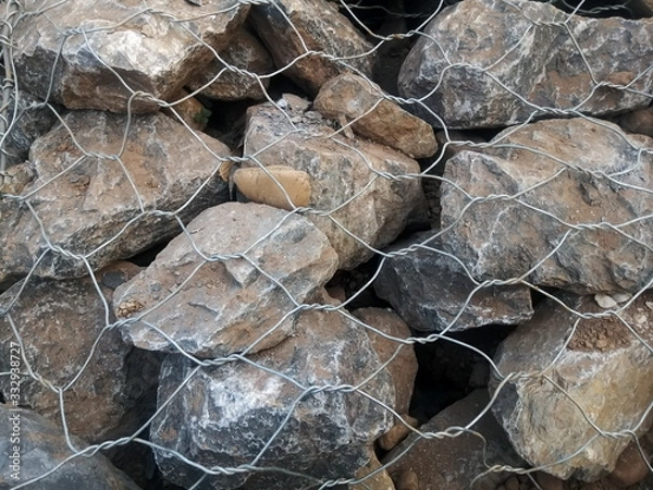 Fototapeta Limestone in wire mesh for construction.