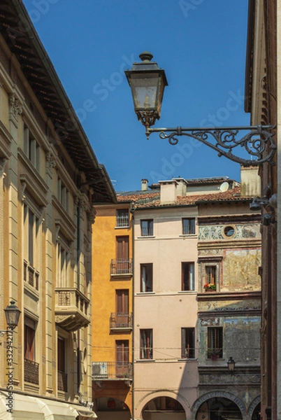 Obraz A Street Of Mantua. Lanterns and old murals on the walls of houses. Italy. Soft focus and blurry background.