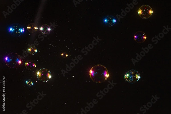 Obraz Soap bubbles isolated on a black background. Copy space.