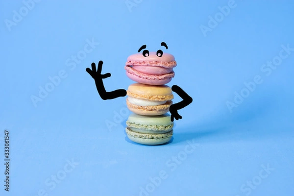 Fototapeta cartoon drawn on coloured macarons on a blue background