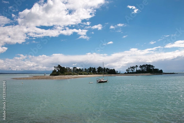 Fototapeta Beautiful tiny island in the tropical seawith a boat, calm summer seascape